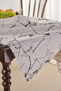 Detail of grey marble pattern tablecloth with cotton linen texture on dark wooden table