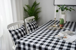 Close-up of black and white gingham tablecloth with premium cotton linen texture and detail