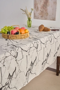 Detail of white marble print tablecloth in linen cotton with elegant table setting