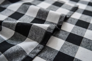 Macro shot of high-quality black and white buffalo check fabric with refined stitching