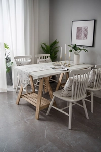 Detail view of marble patterned table runner and matching pillows in a Nordic dining setting