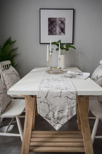 Macro detail of marble pattern table runner with pointed edges in modern dining room