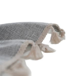 Nordic checkered tablecloth with embroidery and tassel fringe details on grey fabric