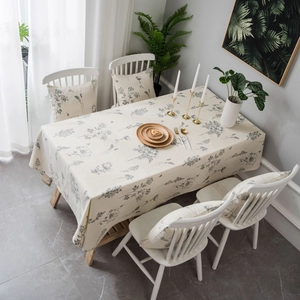Linen rectangle tablecloth and cushion set with grey floral sketch prints in a cozy room