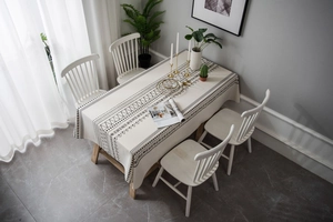 Detailed pattern of Bohemian cream tablecloth with black geometric print and linen texture