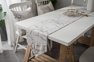 Close-up of modern marble texture table runner with matching cushions for dining decor