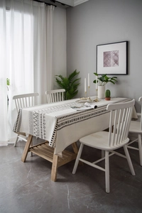 Close-up of Bohemian cotton linen tablecloth with black geometric tribal print in a cozy room