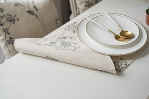 Close-up of linen table runner featuring grey sketch floral print and premium fabric texture