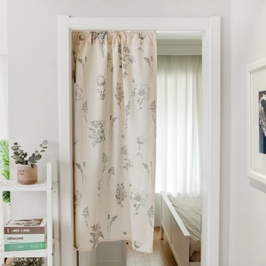 Minimalist beige door curtain with grey floral sketches in a modern home interior