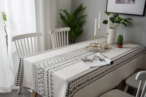 Detail of bohemian geometric print on cotton linen tablecloth with a minimalist home setup