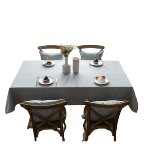 Grey waterproof linen tablecloth and matching cushion set with colorful braided trim