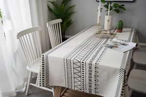 Close-up of Bohemian cotton linen tablecloth with black geometric print and thick texture