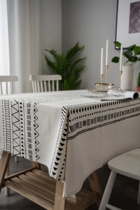 Detail of bohemian cotton linen tablecloth with black geometric print and textured fabric