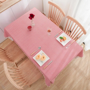 Red and white checkered tablecloth with lace edges on a rectangular dining table