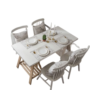 Modern white dining table set with marble pattern placemats and light wood legs