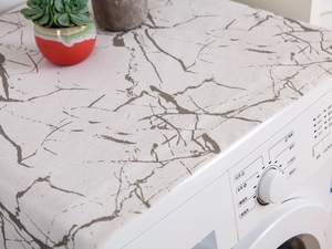 Macro view of white marble texture dust cover for washing machine in a modern home