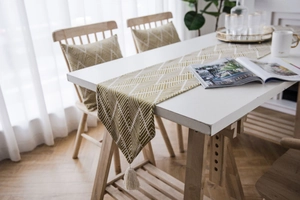 Detail of Nordic jacquard geometric table runner with tassels and matching pillowcase
