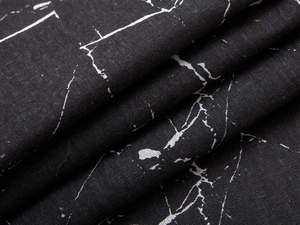 Close-up detail of modern black marble print fabric with high-density textile texture
