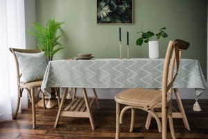 Detail of navy blue waterproof tablecloth with geometric patterns and beige tassels