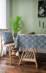 Detailed close-up of navy blue waterproof tablecloth with geometric pattern and white tassels