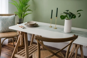 Detail of Nordic geometric jacquard table runner with fringe and green herringbone pattern