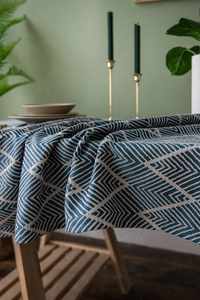 Detailed close-up of navy blue waterproof jacquard tablecloth with tassel fringe detail
