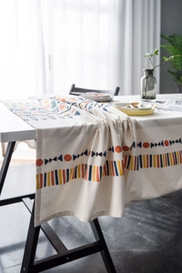 Detail of bohemian cotton linen table runner with vibrant geometric patterns and tassels