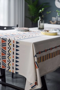 Close-up of bohemian geometric patterns and linen texture on this square tablecloth