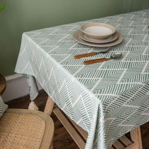 Navy blue waterproof tablecloth with geometric herringbone pattern and white tassels