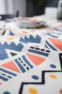 Macro shot of geometric print tablecloth showing detailed cotton linen fabric texture