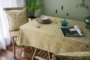 Detail der gelben geometrischen Jacquard-Tischdecke mit weißen Quasten und rustikaler Webung