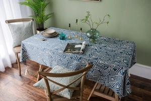 Close-up of blue geometric cotton linen tablecloth featuring decorative white edge tassels