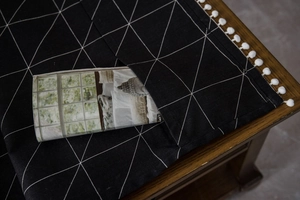 Detail of cotton linen table runner with geometric pattern and side storage pocket