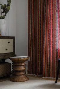 Detail of bohemian striped cotton linen curtain with elegant white lace trim edge