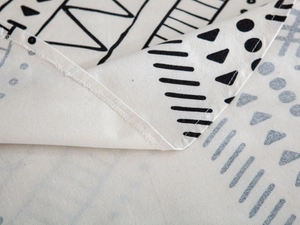 Detail of bohemian black and white geometric pattern on cotton linen tablecloth fabric