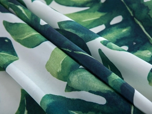 Detail view of waterproof green monstera leaf print fabric for tablecloth or decor