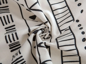 Detailed close-up of Bohemian geometric pattern print on woven cotton linen fabric