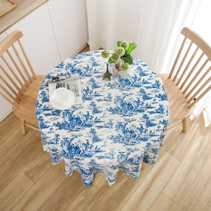 Blue and white French Toile de Jouy floral pattern round tablecloth on a wooden dining table