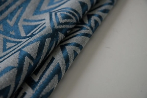Close-up of thick navy and grey woven fabric with geometric triangle pattern and texture