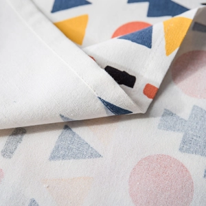 Bohemian geometric printed tablecloth with linen texture and detailed stitching detail