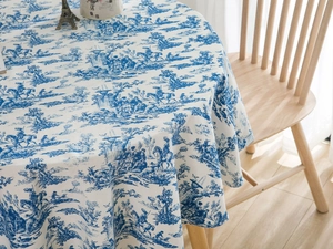 Detailed close-up of blue Toile de Jouy pattern on premium round linen tablecloth