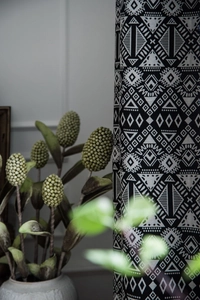 Detail of geometric black and white bohemian curtain fabric with rustic cotton linen texture