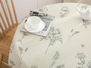 Close-up of circular cotton linen tablecloth with elegant grey floral sketch patterns