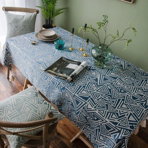 Blue and white geometric triangle tablecloth with tassel fringe and matching chair cushions