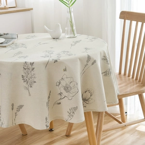 Minimalist round linen tablecloth with elegant grey floral print on a light beige base