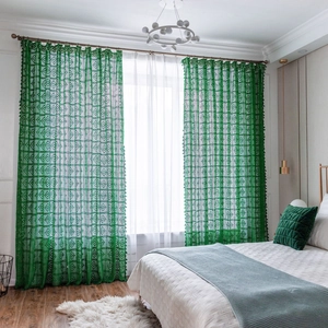 Vintage green crochet hollow curtains with elegant tassels in a rustic farmhouse style