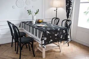 Detail of piano keys and musical notes print on black and white tablecloth fabric