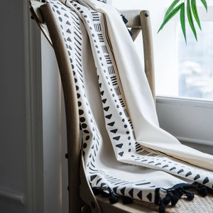 Bohemian black and white print cotton linen curtains with tassels on wooden chair