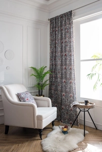 Detail of vintage paisley floral curtains with elegant white tassel trim and matching pillow
