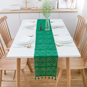 Vintage green handmade crochet table runner with hollow floral lace and tassel accents